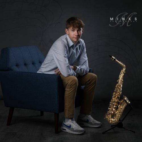 senior portrait of guy with saxophone
