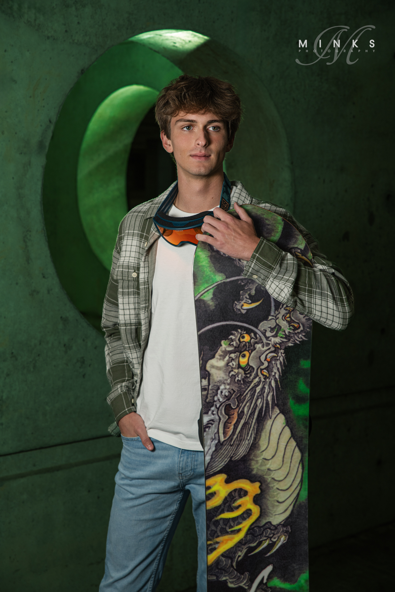 high school senior guy holding his snowboard
