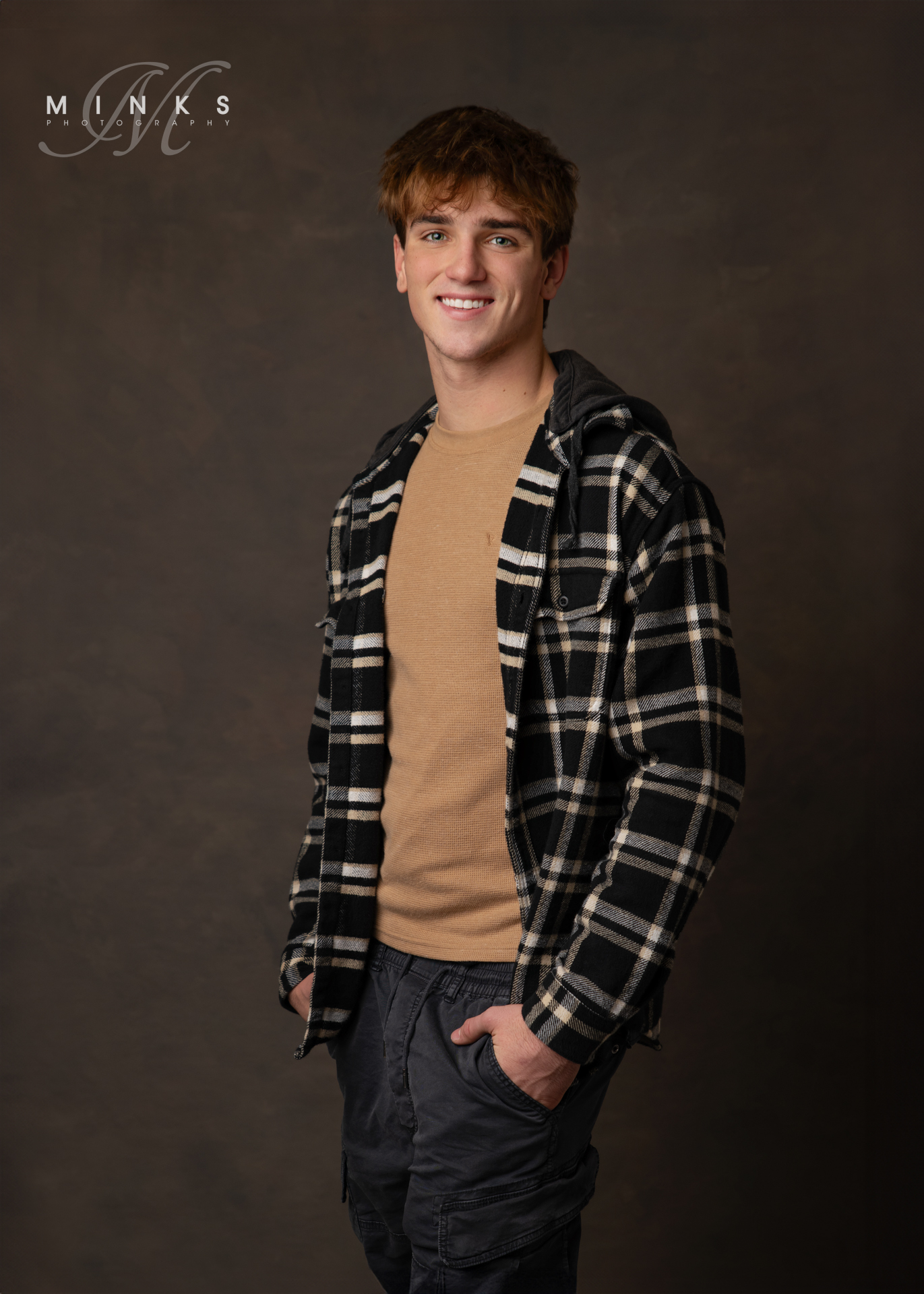 studio senior picture of a guy standing